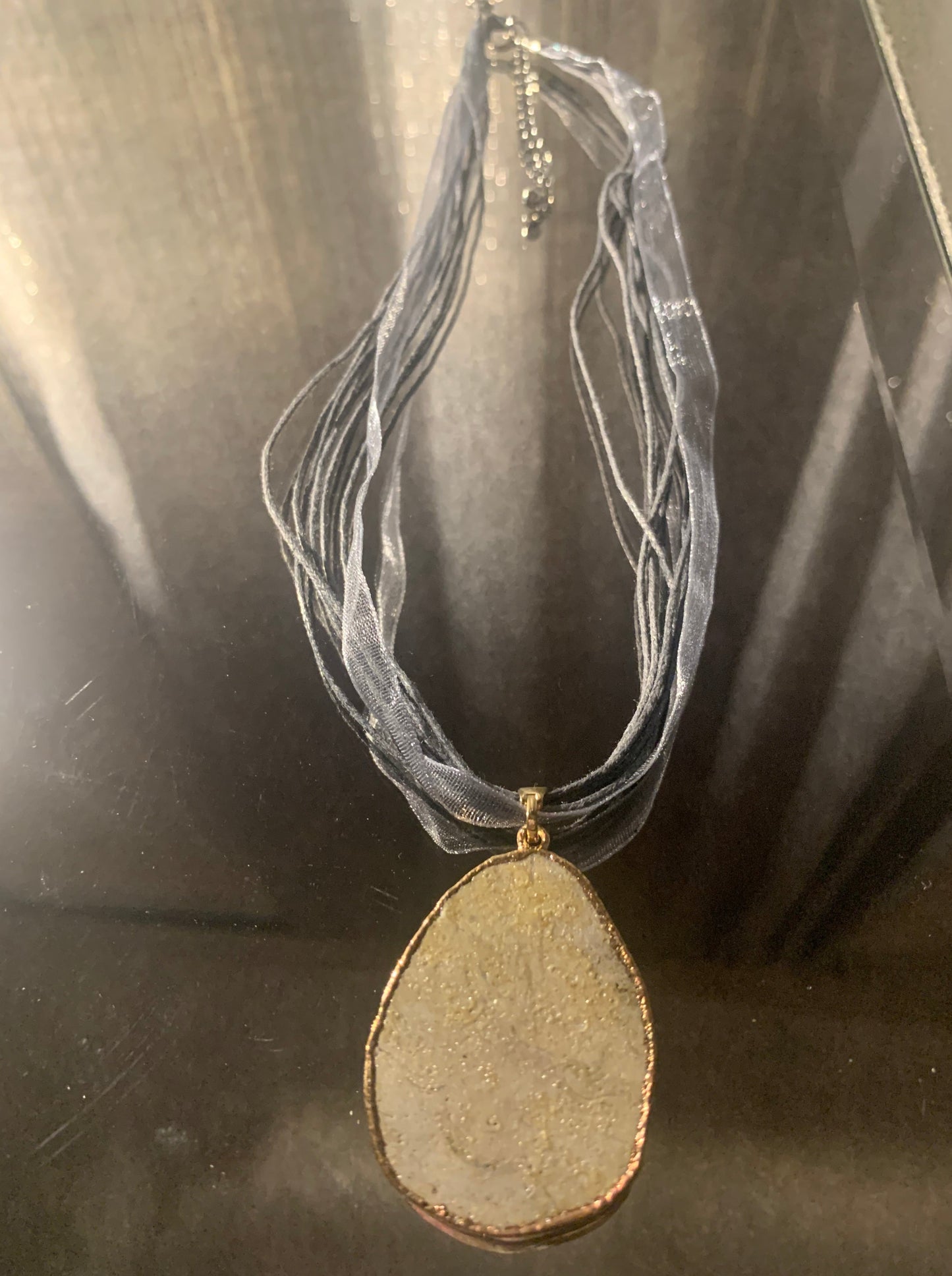 Necklace, Naturally Pave' Pewter Stone framed in gold accented with 18" nylon ribbon and cord finished with lobster clasp and extension chain.